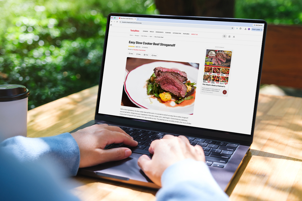 Laptop displaying a digital circular with recipe content and weekly deals